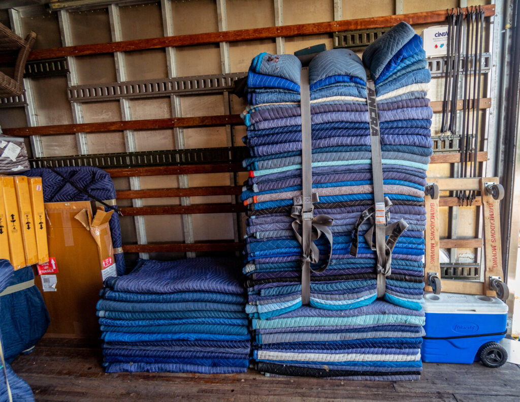 All furniture is wrapped with quilted blankets before it gets on the truck. The blankets are even blue… and buttery soft.